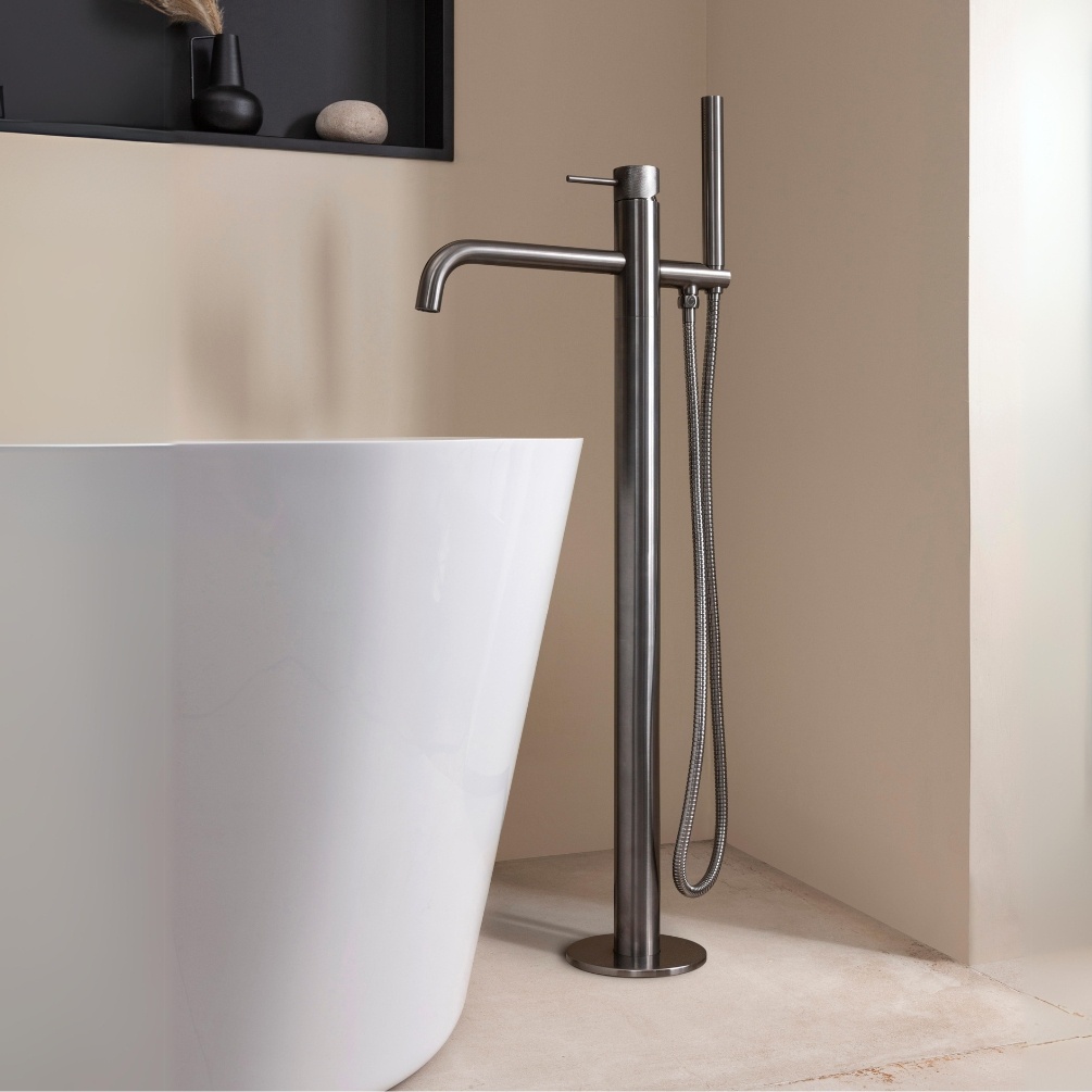 Close up product lifestyle image of the JTP Vos Brushed Black Floorstanding Bath Shower Mixer